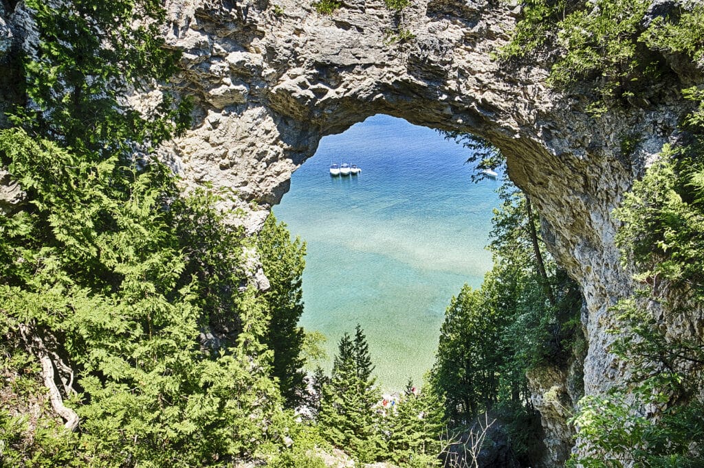 Three Boats On Lake Huron Are Moored Together Underneath Arch Ro