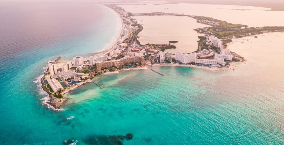 Aerial coastal view of Cancun featured in Resort Concierge Escapes travel editorial content.